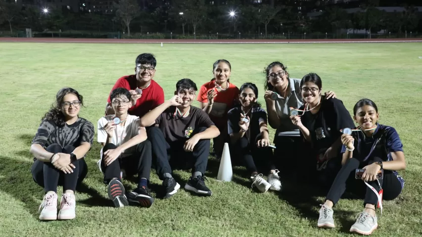 Team posing with medals after sport event