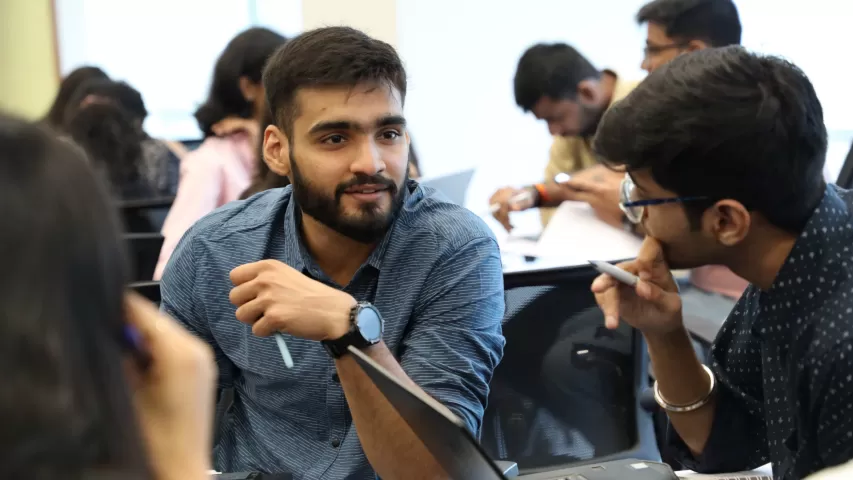 Students discussing math boot camp problems